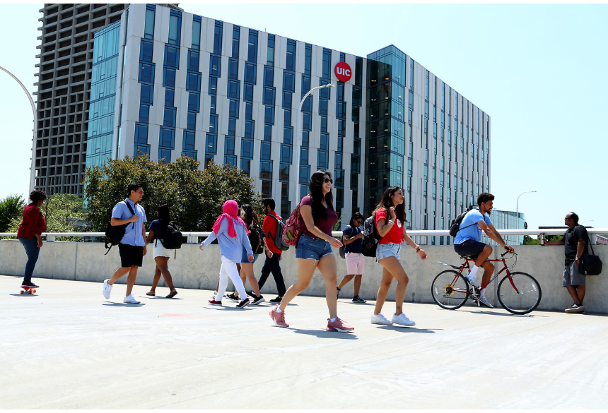 Students walking, biking, and skateboarding on UIC campus