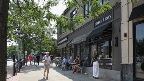 Street with tables outside and many windows facing street