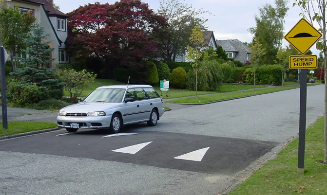A car going over a speed hump