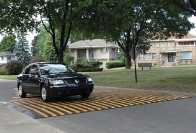 A car driving over speed table in a residential area